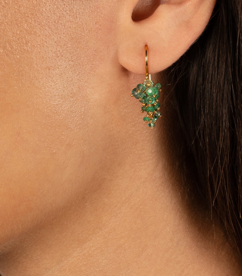 Emerald drop earrings in gold vermeil close up on a model