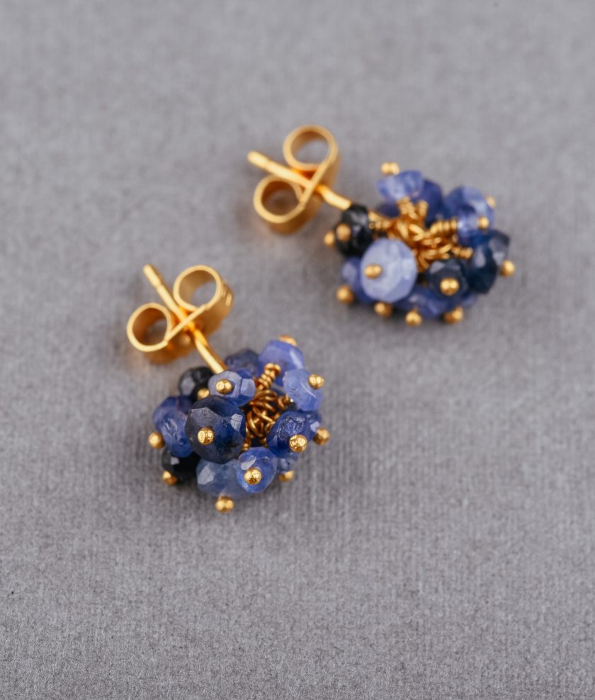 Photo of blue sapphire earrings on a grey background