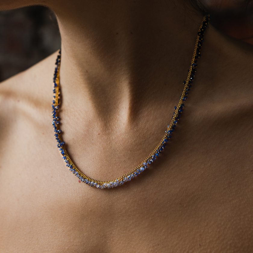 Model in a sapphire beaded necklace