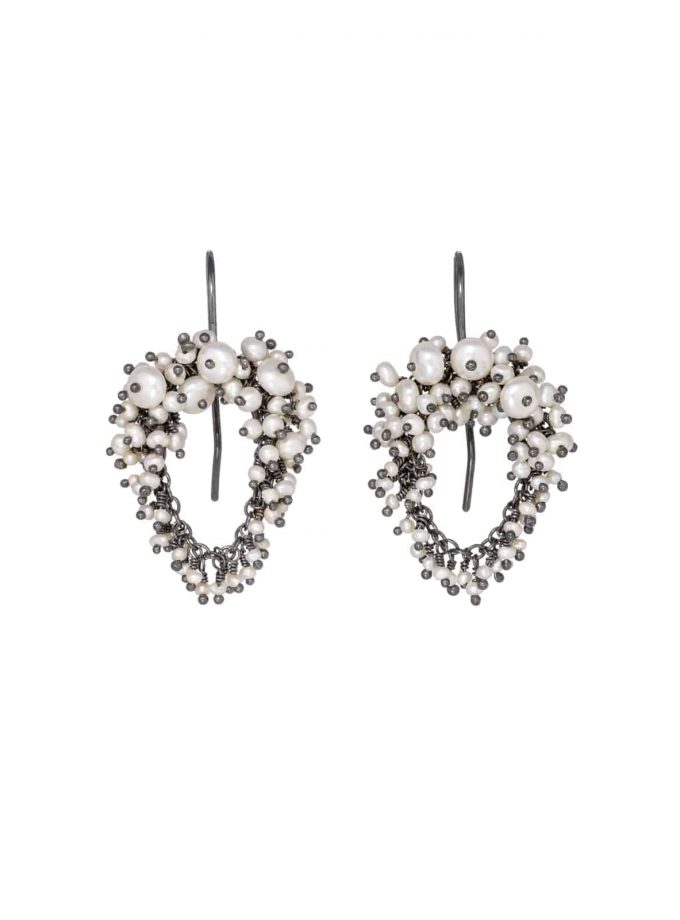 Photo of pearl and oxidised silver beaded earrings on white background