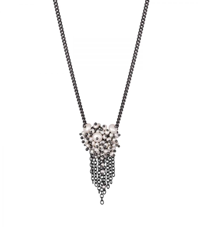 Photo of pearl and oxidised silver chain necklace on white background.
