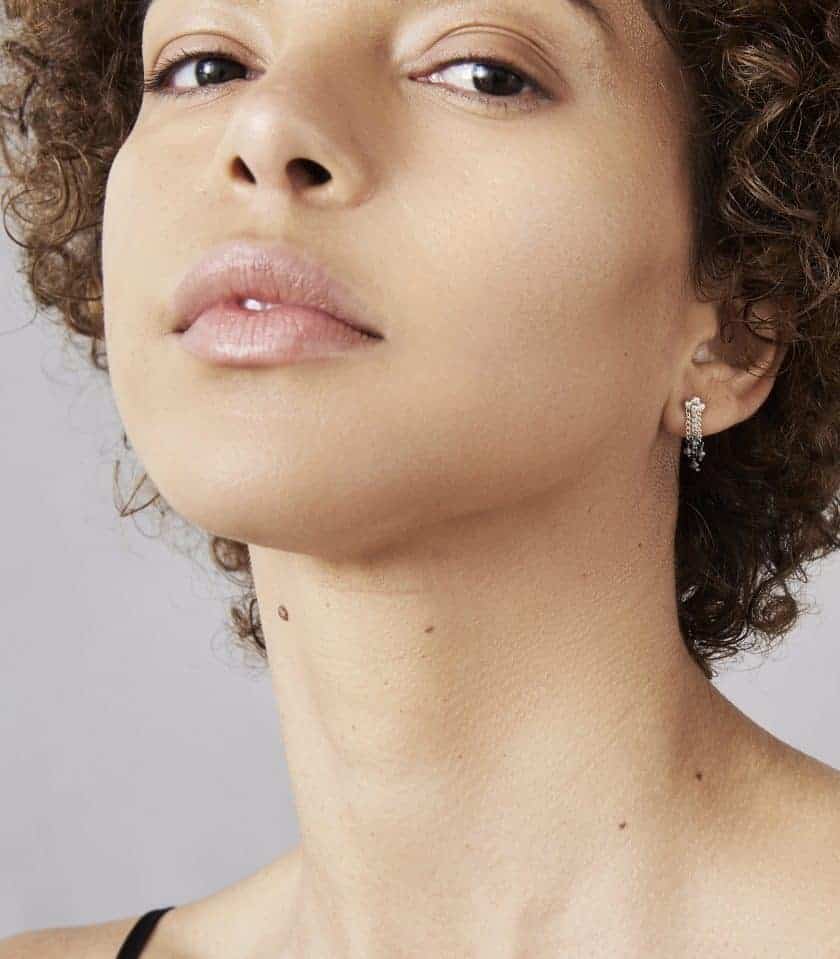 Model wearing diamond and sterling sliver earrings