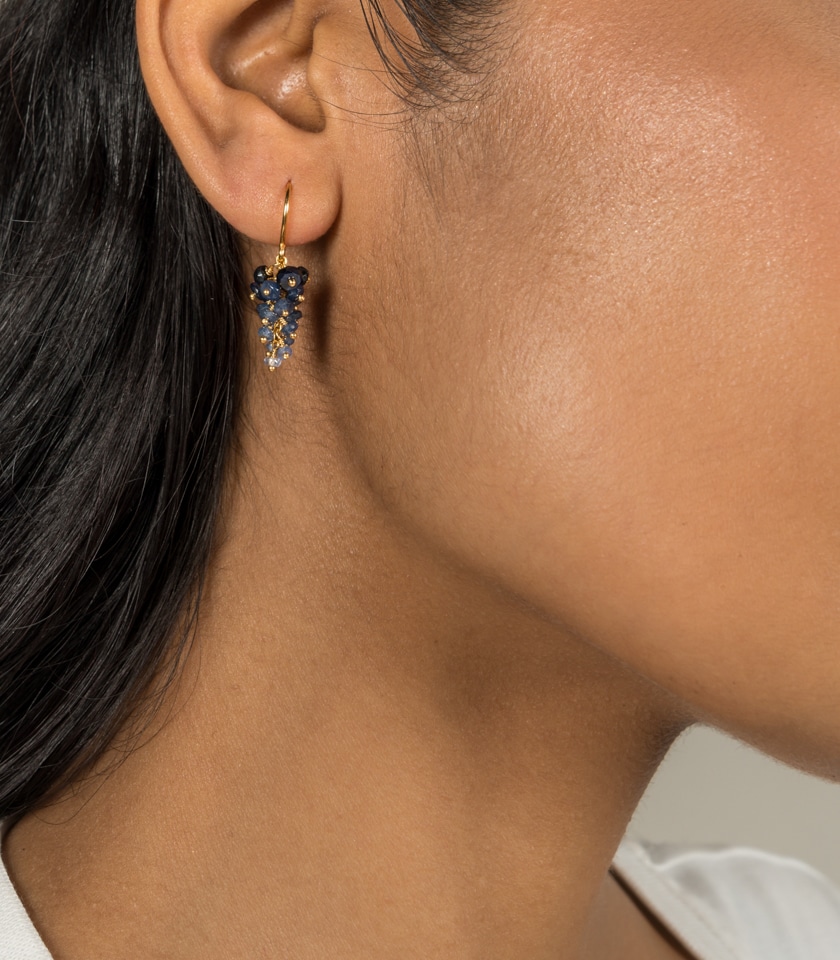Sapphire grape earrings worn by a model