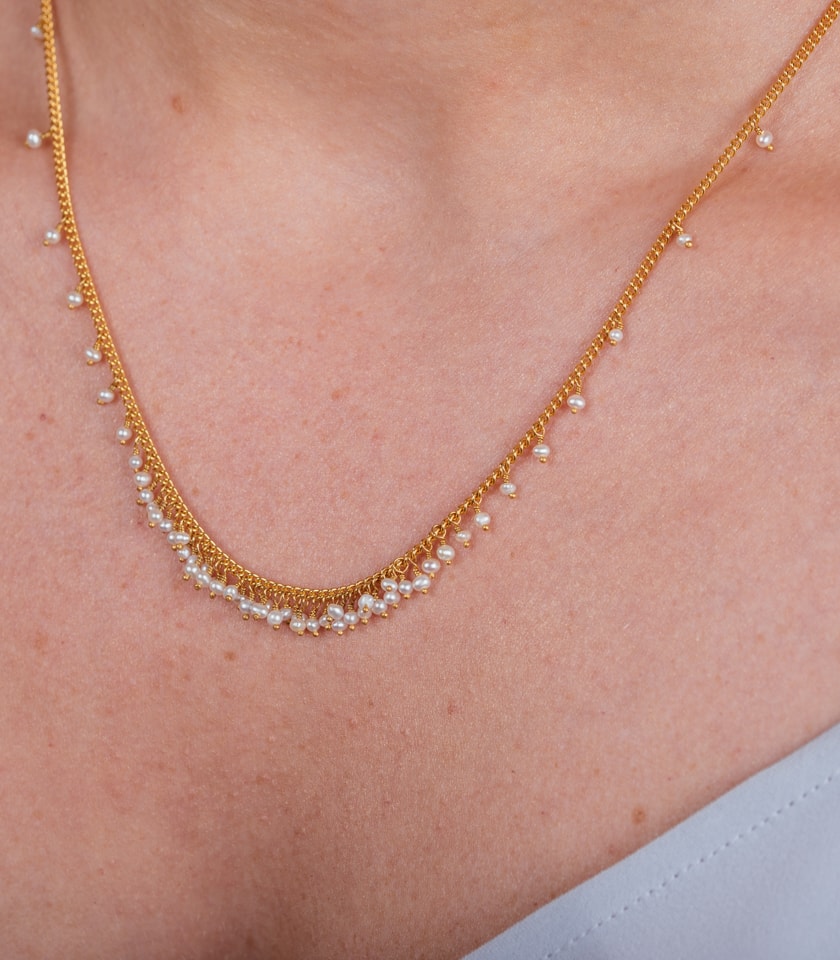 Pearl and gold plated silver necklace worn by a model