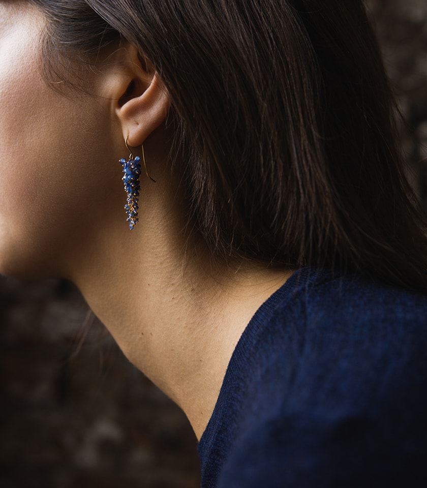 Model wearing blue sapphire drop earrings
