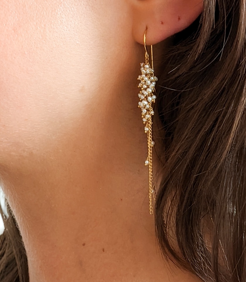 Close up of Photo of a model wearing pearl cluster earrings