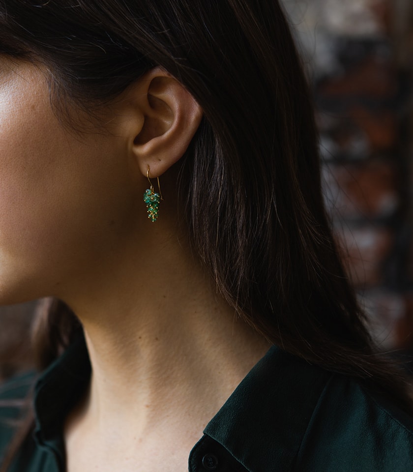 Model wearing emerald drop earrings