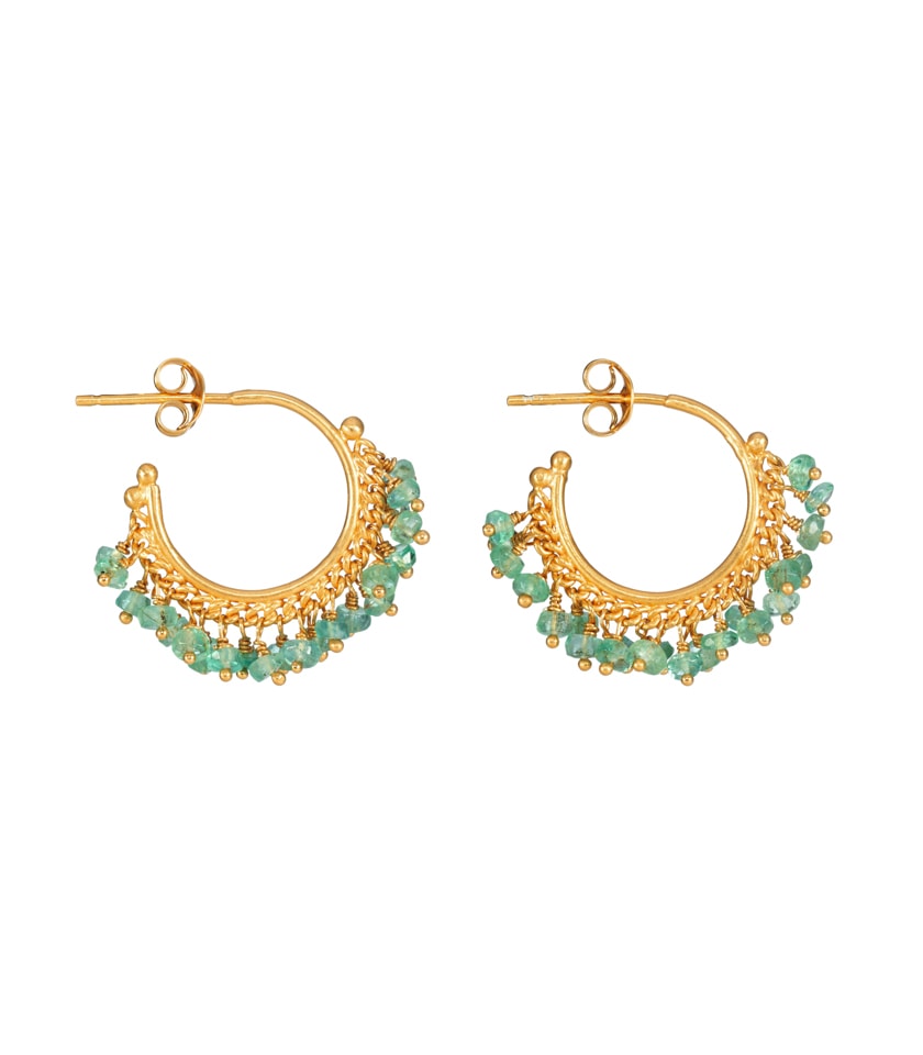 Side view of a pair of gold and emerald hoop earrings