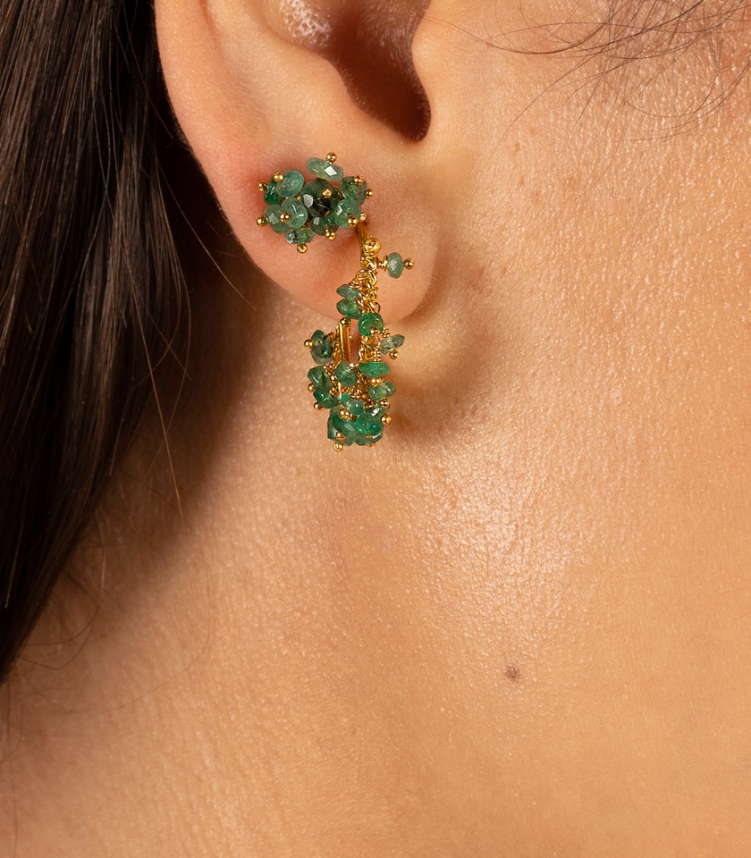 Hoop earrings and stud earrings in green emerald, close up shot on a model