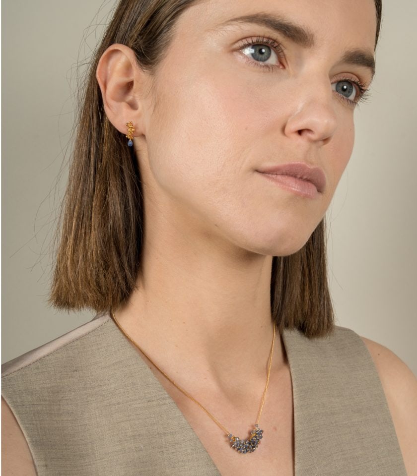 Sapphire droplet earrings worn by a model